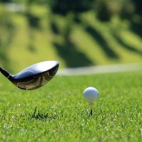 golf ball on tee and golf club