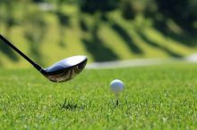 golf ball on tee and golf club